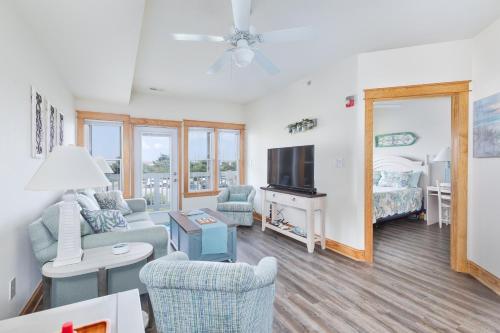a living room with a couch and a tv at C103A - Sweet Sound Memories in Nags Head