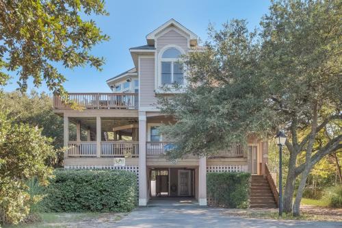 a large house with a porch and a balcony at 4482 - Villa Al Mare in Duck