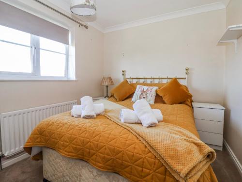 a bedroom with a large bed with two towels at Thorntons House in Northallerton