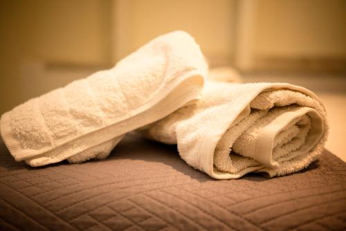 a white towel sitting on top of a bed at Ektoras House in Platamonas