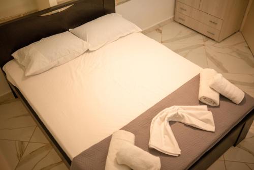 a bed with two towels on it in a room at Ektoras House in Platamonas