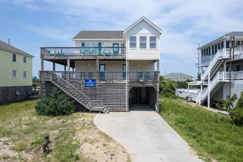 a house with a staircase leading up to it at 7676 - Nautical by Nature in Avon