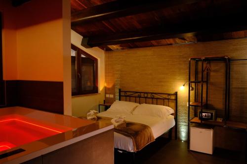 a bedroom with a bed and a bath tub at La Maraviglia in Foligno