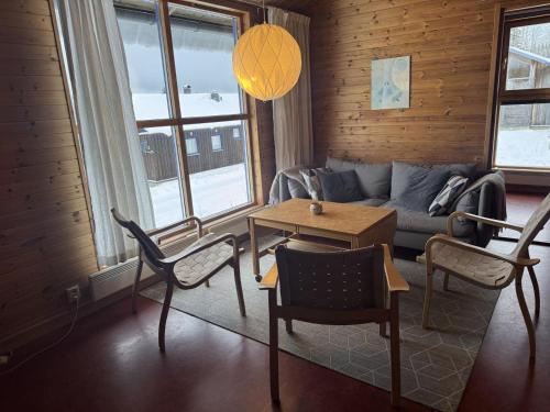a living room with a couch and a table at Skutstuga 6 - Gruvbacken Huså in Järpen