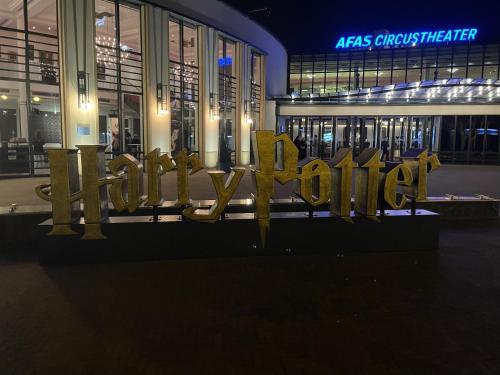 a sign in front of a building at night at Hotel Plato by Hofstad Studios in Scheveningen
