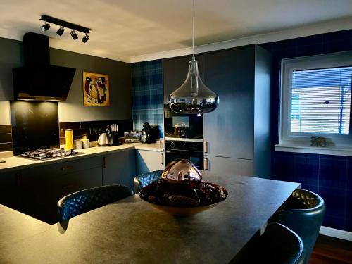 a kitchen with a table with a bowl on it at Holiday Apartment, Balloch, Loch Lomond in Balloch