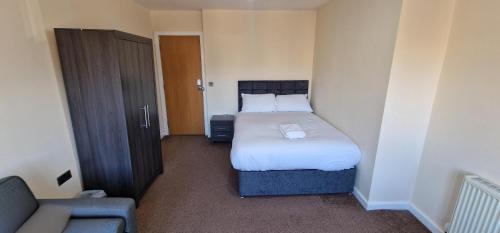 a small bedroom with a bed and a couch at SELF CHECK-IN PENTHOUSE APARTMENT in HALIFAX CENTRE in Halifax