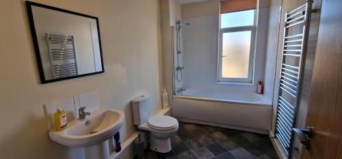 a bathroom with a sink and a toilet and a shower at SELF CHECK-IN PENTHOUSE APARTMENT in HALIFAX CENTRE in Halifax