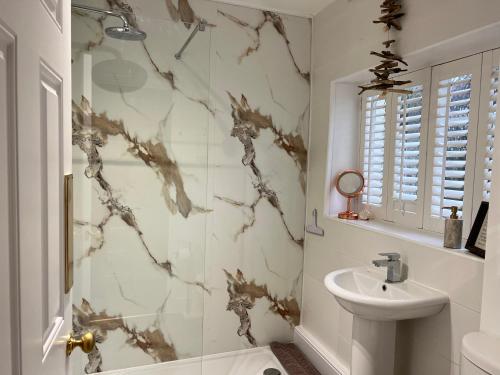 a bathroom with a sink and a shower at Church View a first floor apartment in the heart of historic Topsham in Topsham