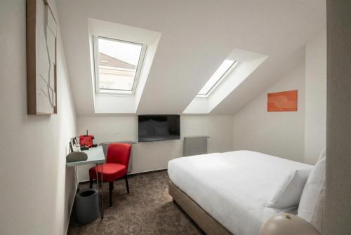 a bedroom with a bed and a desk with a red chair at Boutique Hotel Prokopovka 34 in Pilsen