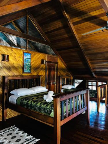 a bedroom with a bed and a wooden ceiling at Beyond Paradise Vacation Rental in Cristo Rey