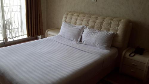 Llit o llits en una habitació de Impress Hotel