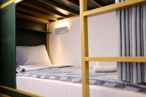 a bunk bed in a small room with a window at Beshic Hostel in Tashkent