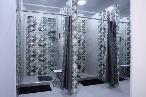 a glass shower door with a bunch of wine glasses at Beshic Hostel in Tashkent