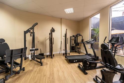 a gym with several treadmills and exercise bikes at Amazon Park Hotel in Belém