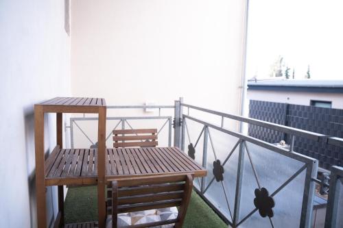 a balcony with a wooden table and two chairs at Design Apartment - Solingen-Mitte - Balkon - BRIGHT Collection in Solingen