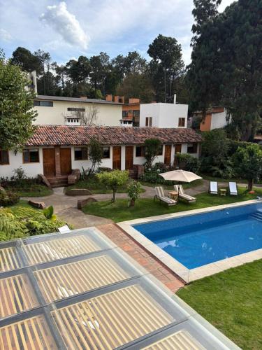 an image of a house with a swimming pool at Hotel las Caballerizas in Valle de Bravo