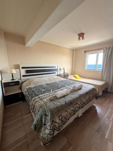 a bedroom with a bed and a window at Departamento Torre IV in Comodoro Rivadavia