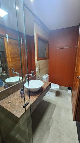 a bathroom with two sinks and a glass shower at Casa Violeta in Ouro Preto