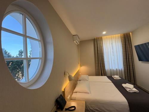 a bedroom with a large window and a bed at Eco Nieborów in Nieborów