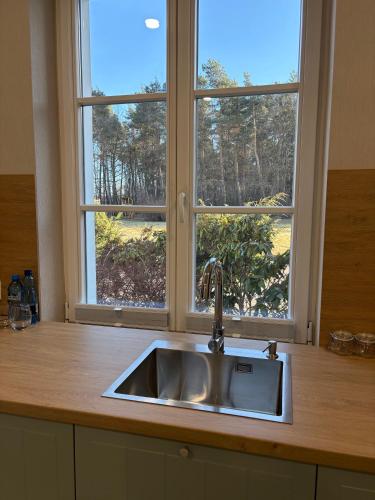 a kitchen counter with a sink and a window at Eco Nieborów in Nieborów