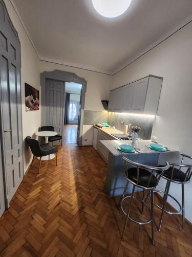 a kitchen with a table and chairs in a room at Central old town escape in Timişoara