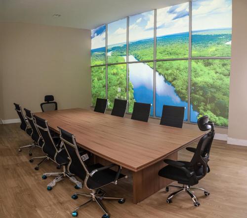 a conference room with a large table and chairs at Amazon Park Hotel in Belém