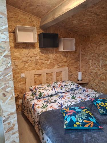 a bedroom with a bed in a stone wall at Chez Marie in Le Pallet