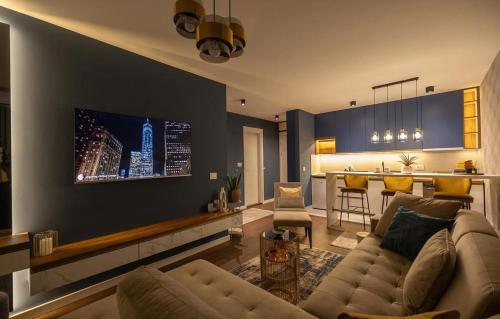 a living room with a couch and a kitchen at Impresia apartments in Kragujevac