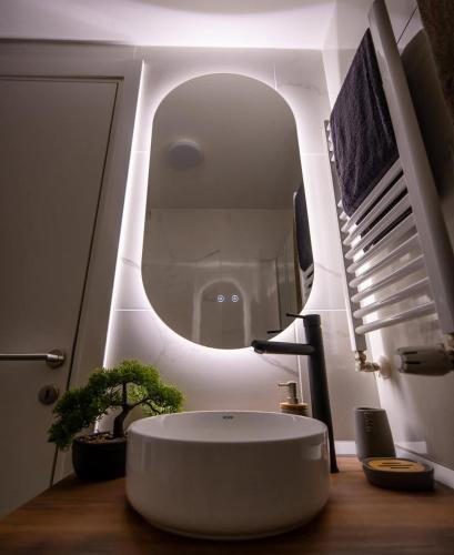 a bathroom with a white sink and a mirror at Impresia apartments in Kragujevac