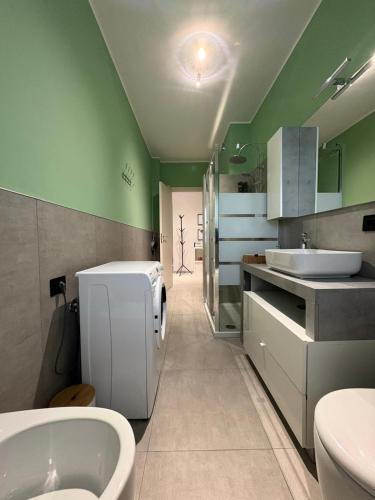 a bathroom with a sink and a toilet and a tub at Ladybug in Canale