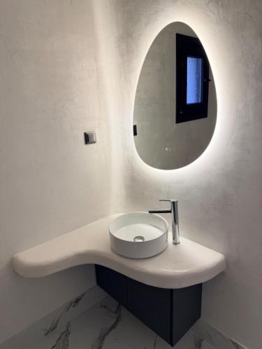 a bathroom with a sink and a mirror at Mirage Luxury Living in Nea Potidaea