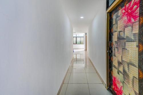 a hallway with a large painting on the wall at Hotel O Utrishree in Khandagiri