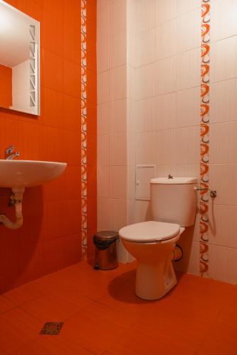 a bathroom with a toilet and a sink at Студио 3 Слънчево Утро in Hisarya
