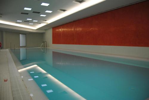 a swimming pool in a building with a large swimming pool at Ribera del Marlin - Sotogrande in Sotogrande