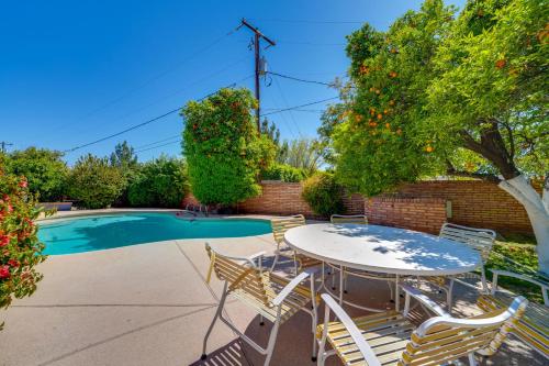 a patio with a table and chairs next to a pool at Golf, Swim and Grill Out Phoenix Gem 10 Mi to Dtwn in Phoenix