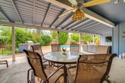 a patio with a table and chairs and a ceiling fan at Golf, Swim and Grill Out Phoenix Gem 10 Mi to Dtwn in Phoenix