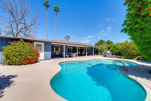 a swimming pool in front of a house at Golf, Swim and Grill Out Phoenix Gem 10 Mi to Dtwn in Phoenix