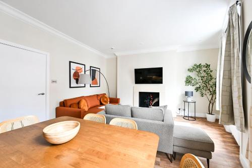 a living room with a couch and a table at Stylish Marylebone Apartments in London