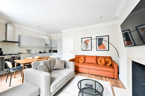 a living room with a couch and a table at Stylish Marylebone Apartments in London