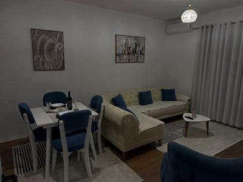 a living room with a couch and a table at Golden Apartment 1 in Kamëz