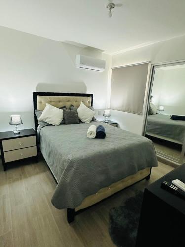 a bedroom with a bed with a hat on it at Residencia tropical jardines 3 in Punta Cana