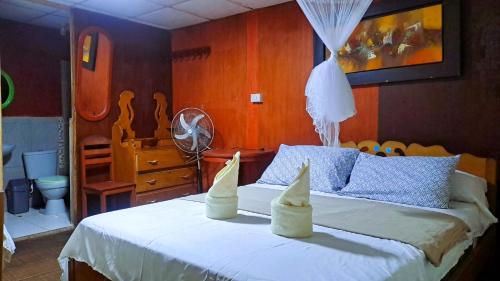 a bedroom with a bed with two sand castles on it at Amazon Bromelia Lodge & Expeditions in Iquitos