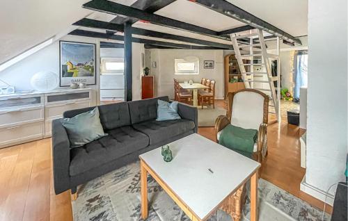 a living room with a couch and a table at 1 Bedroom Gorgeous Apartment In Samsø in Ballen