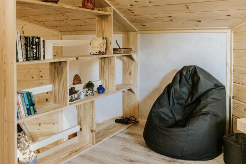 a room with a bean bag chair in a room with wooden shelves at Cisza Traw in Rabka-Zdroj