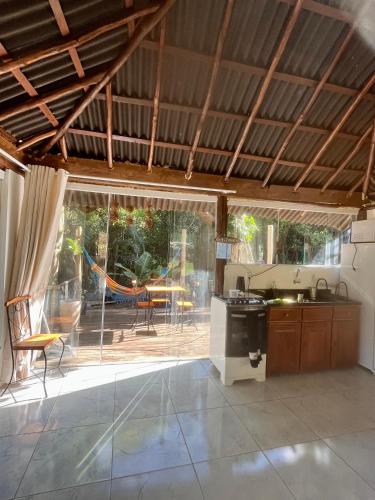 a kitchen and dining room with a view of a patio at Reserva da Reserva Praia do Forte in Mata de Sao Joao