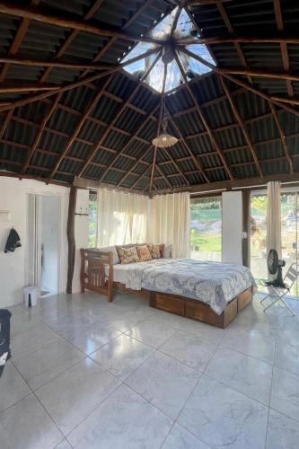 a large bedroom with a bed and a ceiling at Reserva da Reserva Praia do Forte in Mata de Sao Joao