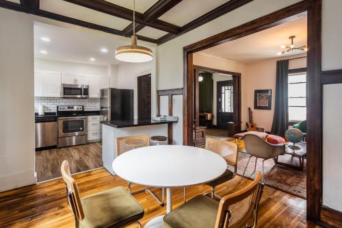 a kitchen and living room with a table and chairs at Luxe Mid-Century Styled Historic Townhouse #1 in Detroit