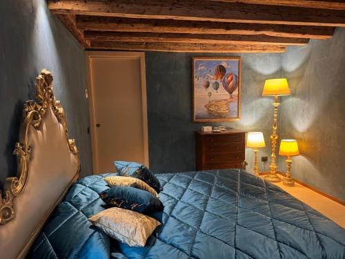a bedroom with a blue bed with pillows at NEW OPENING San Marco Secret 4343 in Venice