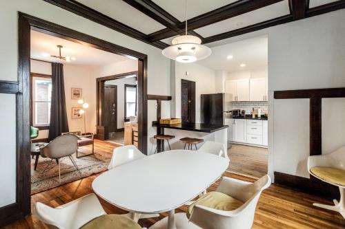 a kitchen and living room with a white table and chairs at Luxe Mid-Century Styled Townhouse #3631 in Detroit